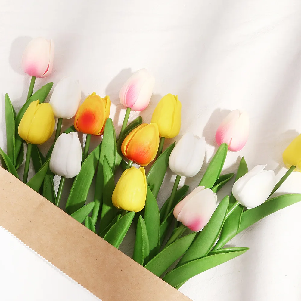 Colorful tulips in a brown paper bouquet.