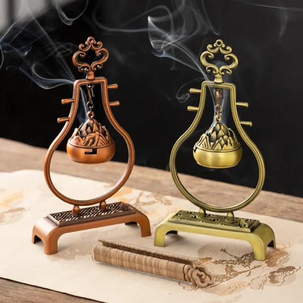 Elegant incense holders with smoke on a table.