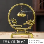 Brass incense burner with deer and tree design.