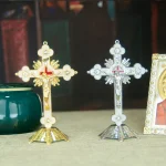 Gold and silver crucifixes on display table.
