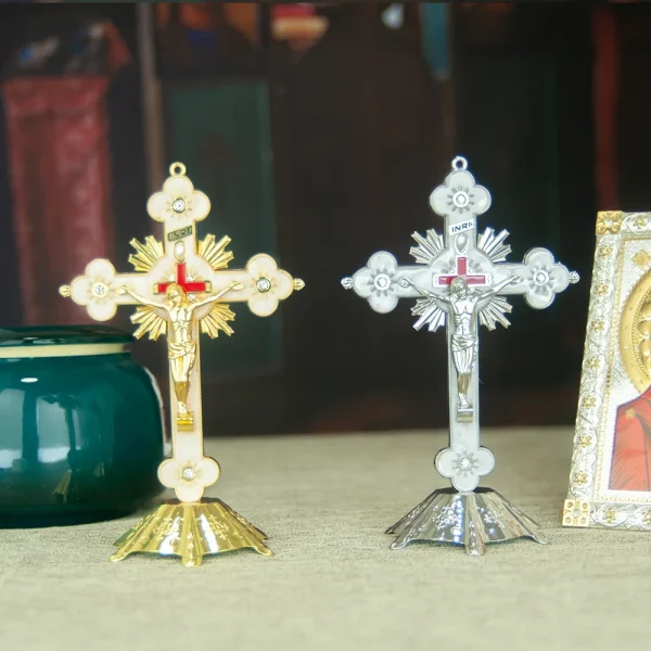 Gold and silver crucifixes on display table.