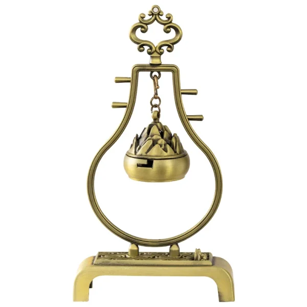 Vintage brass incense holder with intricate design.