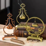 Decorative incense burners on a wooden table.
