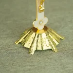 Ornate gold stand with floral design
